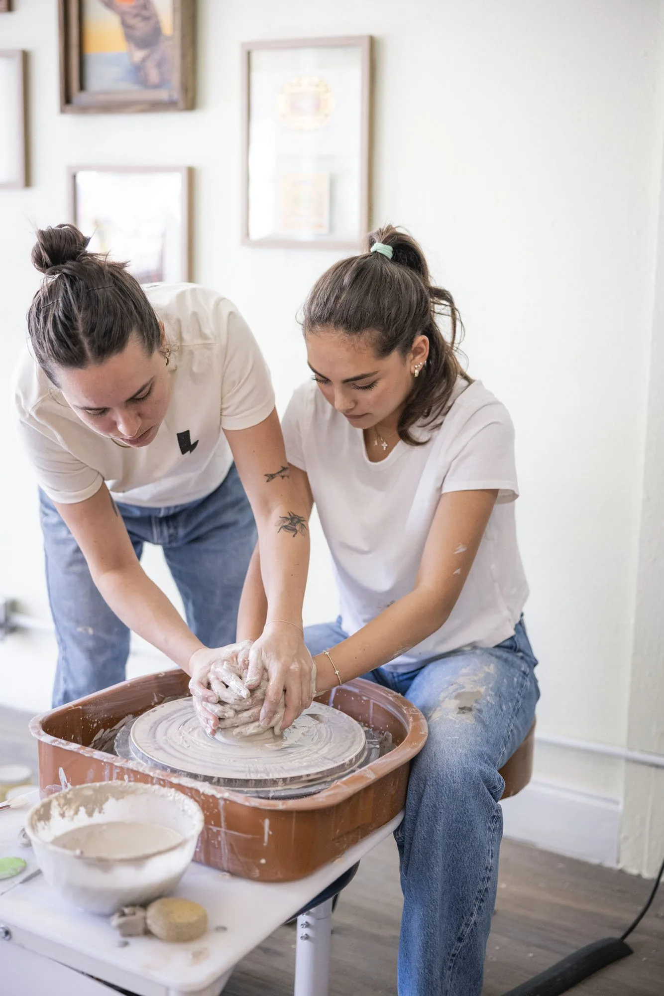 Student shaping clay on a pottery wheel at Floridian Ceramics Tampa